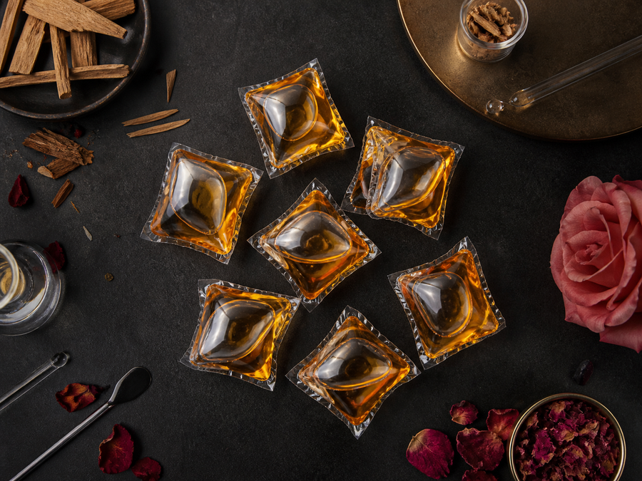 LAVO amber laundry pods styled with perfume notes and rose petals
